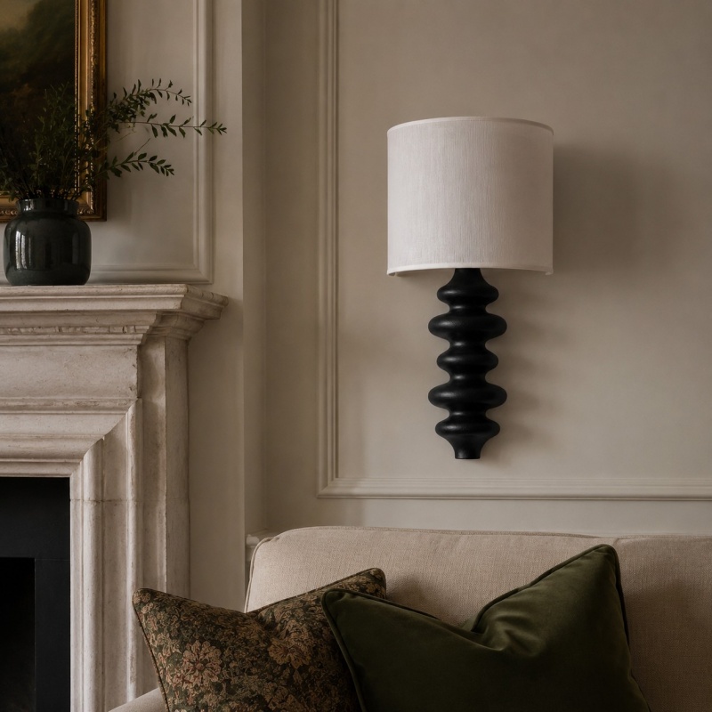 Ebony wall lamp installed beside a fireplace